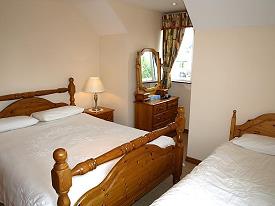 Room with a double and a single bed